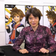 Masahiro Sakurai sits at a desk, wearing a purple shirt.